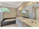 Main bathroom offers a soaking tub, walk-in shower, and double sink vanity at 4957 Sabal Lake Cir, Sarasota, FL 34238