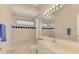 Bright bathroom features a tub and shower combo and a single sink vanity at 4957 Sabal Lake Cir, Sarasota, FL 34238