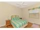 Bedroom with bed, wood floors, fan and bright window at 4957 Sabal Lake Cir, Sarasota, FL 34238