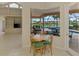 Bright breakfast nook with a view of the pool and a spacious backyard overlooking the community lake at 4957 Sabal Lake Cir, Sarasota, FL 34238