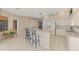 Large open kitchen with breakfast bar, white appliances, and adjacent breakfast nook at 4957 Sabal Lake Cir, Sarasota, FL 34238