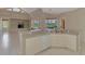 Bright, open-concept kitchen featuring a breakfast bar with views of the backyard and living area at 4957 Sabal Lake Cir, Sarasota, FL 34238