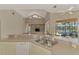 Bright open kitchen featuring a breakfast bar with views of the living area, backyard, and pool at 4957 Sabal Lake Cir, Sarasota, FL 34238