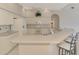Bright kitchen featuring white appliances, plenty of cabinets, and a breakfast bar with seating at 4957 Sabal Lake Cir, Sarasota, FL 34238