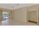 Bright living room with tile flooring and sliding glass doors leading to the lanai and pool at 4957 Sabal Lake Cir, Sarasota, FL 34238