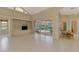 Living room featuring a built-in shelving unit, tiled floors, and backyard pool views at 4957 Sabal Lake Cir, Sarasota, FL 34238