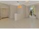 Bright living room with tiled floor, large window, and double doors to exterior at 4957 Sabal Lake Cir, Sarasota, FL 34238