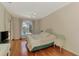 Bright main bedroom features wood floors, fan, and view of pool and lake at 4957 Sabal Lake Cir, Sarasota, FL 34238
