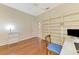 Home office with wood floors and built-in shelves for storage at 4957 Sabal Lake Cir, Sarasota, FL 34238