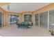Wide patio includes dining set, multiple sliding doors, and a view of the screened-in lanai at 4957 Sabal Lake Cir, Sarasota, FL 34238
