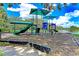View of the community playground area with a slide, climbing structure and canopied picnic table at 4957 Sabal Lake Cir, Sarasota, FL 34238