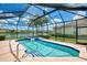 Screened-in pool and hot tub with views of the surrounding landscape and clear blue sky at 4957 Sabal Lake Cir, Sarasota, FL 34238