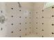 Shower features white tile with black accent tiles and a crystal shower handle at 4957 Sabal Lake Cir, Sarasota, FL 34238