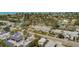 Aerial view of coastal neighborhood featuring canal access, lush landscaping and solar panels on rooftops at 509 Pine Ave # A, Anna Maria, FL 34216