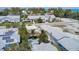 Aerial view featuring houses, colorful exteriors, in-ground pool, and a vintage church at 509 Pine Ave # A, Anna Maria, FL 34216