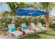 Relaxing backyard with lounge chairs, colorful pillows, and tropical plants offering a private retreat at 509 Pine Ave # A, Anna Maria, FL 34216