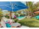 Inviting backyard pool featuring lush tropical landscaping, colorful seating, and a relaxing lounge area for enjoying sunny days at 509 Pine Ave # A, Anna Maria, FL 34216