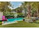 Inviting pool with lush tropical landscaping, and a comfortable seating area for enjoying sunny days at 509 Pine Ave # A, Anna Maria, FL 34216