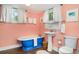 Bathroom featuring a claw foot tub, pedestal sink and matching fixtures in a light colored room at 509 Pine Ave # A, Anna Maria, FL 34216