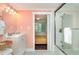 Stylish bathroom featuring a vanity, shower, and a glimpse into the bright, inviting bedroom at 509 Pine Ave # A, Anna Maria, FL 34216