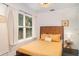 Well-lit bedroom features a full size bed, window, and light neutral tones at 509 Pine Ave # A, Anna Maria, FL 34216