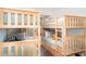 Playful ' bedroom featuring two sets of wooden bunk beds and cozy bedding at 509 Pine Ave # A, Anna Maria, FL 34216