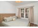 Cozy bedroom with woven headboard, patterned bedding, and a sunlit window for a peaceful retreat at 509 Pine Ave # A, Anna Maria, FL 34216