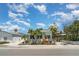 Charming home exterior with mature landscaping, inviting Adirondack chairs, and coastal charm at 509 Pine Ave # A, Anna Maria, FL 34216