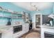 Bright kitchen features open shelving, stainless steel appliances, and modern countertops at 509 Pine Ave # A, Anna Maria, FL 34216