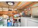 Interior laundry area with washer, dryer, storage shelves and a utility sink at 509 Pine Ave # A, Anna Maria, FL 34216