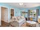 Bright living room with a comfortable sofa, coastal decor, and a view of the outdoors at 509 Pine Ave # A, Anna Maria, FL 34216