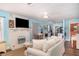 Open-concept living area with a decorative fireplace and seamless flow to the kitchen at 509 Pine Ave # A, Anna Maria, FL 34216