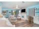 Comfortable living room with a decorative fireplace and ample natural light at 509 Pine Ave # A, Anna Maria, FL 34216