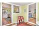 Open living space showcasing a glimpse of the kitchen and living room with a fun retro cooler at 509 Pine Ave # A, Anna Maria, FL 34216