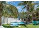 Beautiful pool area with palm trees, seating, and well-maintained turf creating a resort-like ambiance at 509 Pine Ave # A, Anna Maria, FL 34216