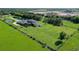 Expansive aerial view of estate home with long driveway, two ponds and large grassy yard at 520 Rye Ne Rd, Bradenton, FL 34212