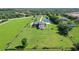 Overhead view of country estate home with mature trees, sprawling lawn and pond at 520 Rye Ne Rd, Bradenton, FL 34212
