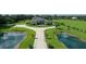 Expansive estate featuring a circular driveway, mature landscaping, and serene ponds with fountains at 520 Rye Ne Rd, Bradenton, FL 34212