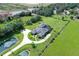 Expansive aerial view of the estate featuring lush green pastures, ponds, and a circular driveway leading to the residence at 520 Rye Ne Rd, Bradenton, FL 34212