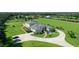 Stunning home with circular driveway, manicured lawns, and mature trees, offering a luxurious and private setting at 520 Rye Ne Rd, Bradenton, FL 34212