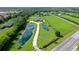 Aerial view of a sprawling property with a long driveway, two ponds, and a beautiful home surrounded by green fields at 520 Rye Ne Rd, Bradenton, FL 34212