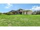 Rear view of home highlighting a screened in porch, covered patio, and beautiful landscaping at 520 Rye Ne Rd, Bradenton, FL 34212
