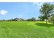 Vast backyard featuring green lawns, mature trees, and plenty of open space for outdoor activities and relaxation at 520 Rye Ne Rd, Bradenton, FL 34212
