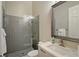 Modern bathroom featuring a glass-enclosed shower, gray tiles, and vanity with a chrome faucet at 520 Rye Ne Rd, Bradenton, FL 34212