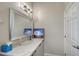 Bathroom featuring a large mirror, vanity with a sink and artwork on the counter at 520 Rye Ne Rd, Bradenton, FL 34212