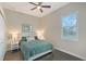 Cozy bedroom featuring a queen bed, ceiling fan, and natural light from the window at 520 Rye Ne Rd, Bradenton, FL 34212