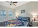 Bedroom with two large windows, ceiling fan, and bedside tables with lamps at 520 Rye Ne Rd, Bradenton, FL 34212