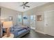Bedroom features a ceiling fan, a television, and a doorway into the bathroom at 520 Rye Ne Rd, Bradenton, FL 34212