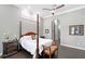 Spacious bedroom featuring a four-poster bed, dark wood floors, and light gray walls at 520 Rye Ne Rd, Bradenton, FL 34212