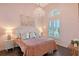 Comfortable bedroom featuring a large bed, chandelier, and a bright window at 520 Rye Ne Rd, Bradenton, FL 34212